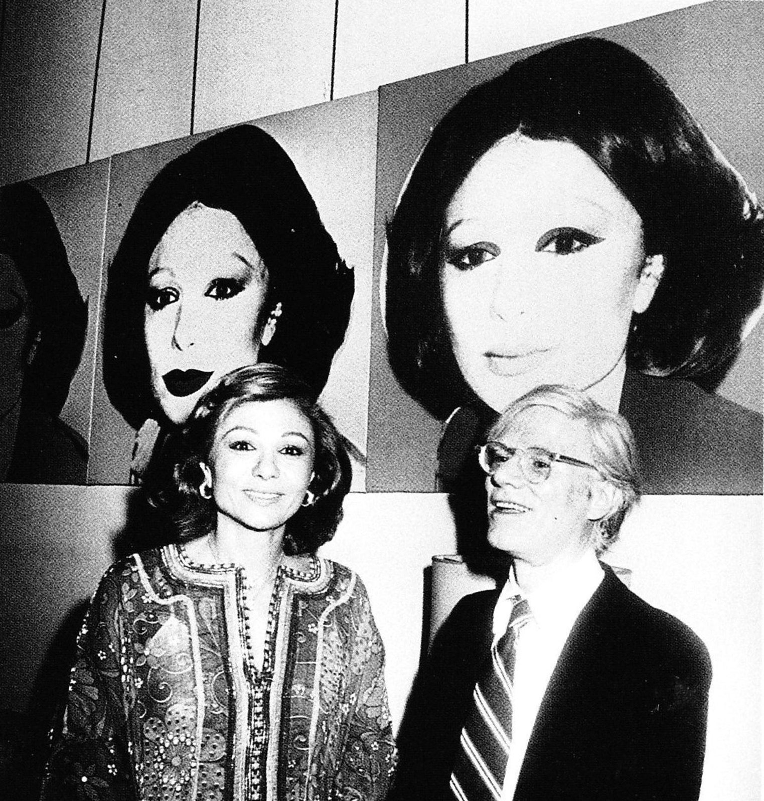 На фоне своего портрета с его автором Энди Уорхолом 1977.