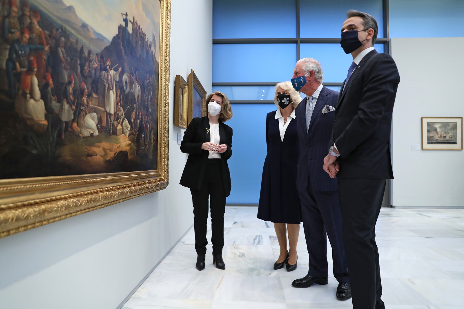 Принц Чарльз Камилла ПаркерБоулз и премьерминистр Греции Кириакос Мицотакис во время посещения Национальной галереи в Афинах