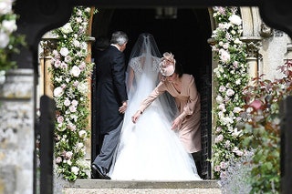 Герцогиня Кэтрин поправляет платье своей сестры.