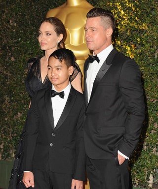Анджелина Джоли и Брэд Питт с сыном Мэддоксом .