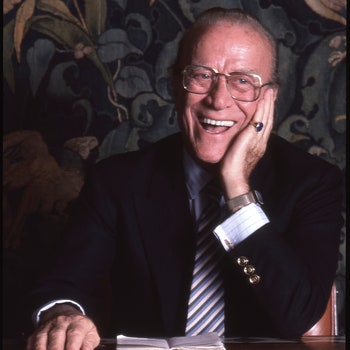 Portrait of Italian fashion designer and Gucci Shop chairman Aldo Gucci  as he laughs seated behind a desk in his office...
